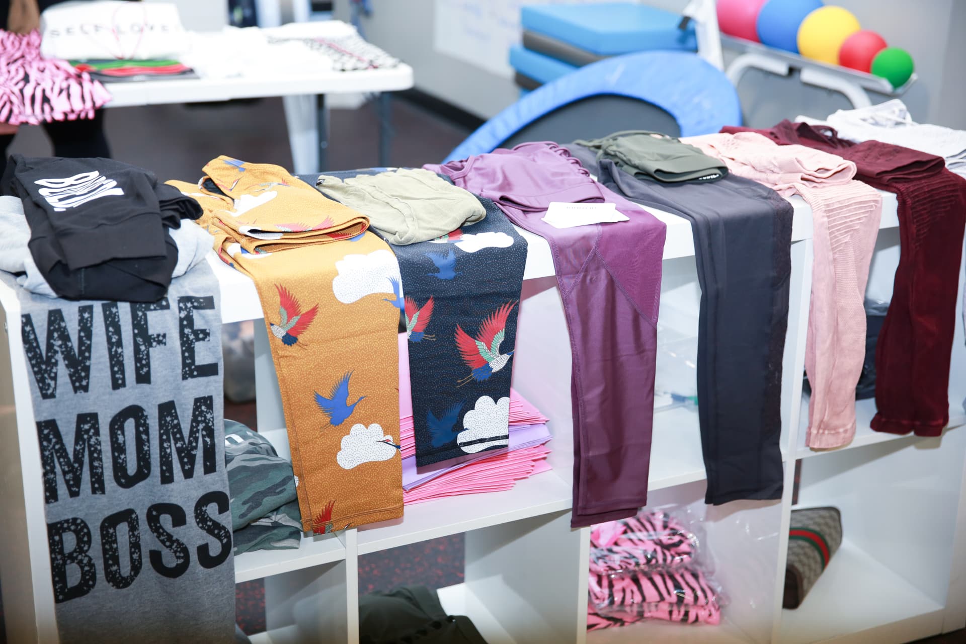 Activewear and Wife Mom Boss tees merchandised on the retail shelving
