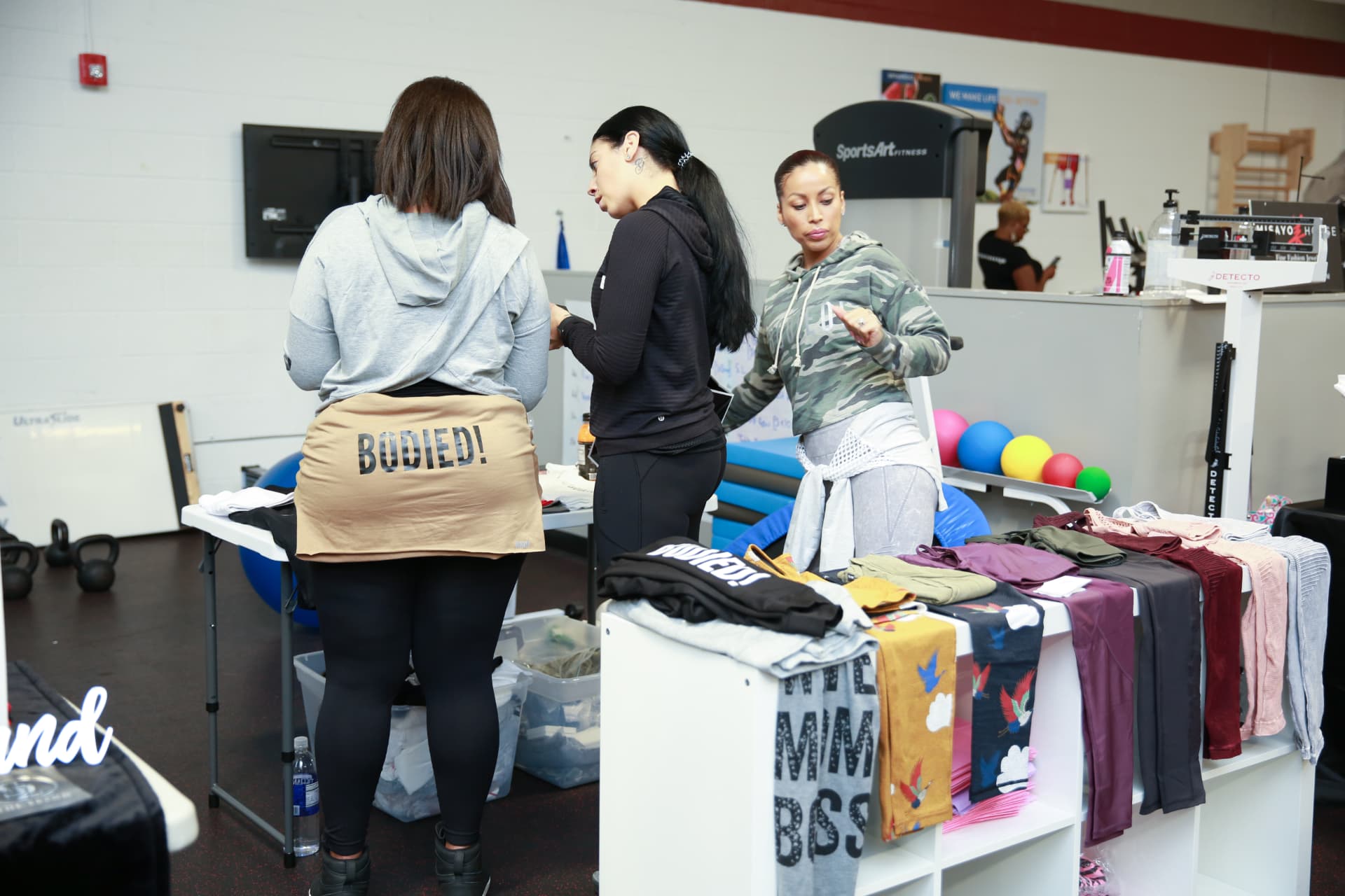 Members shopping the activewear vendor table together