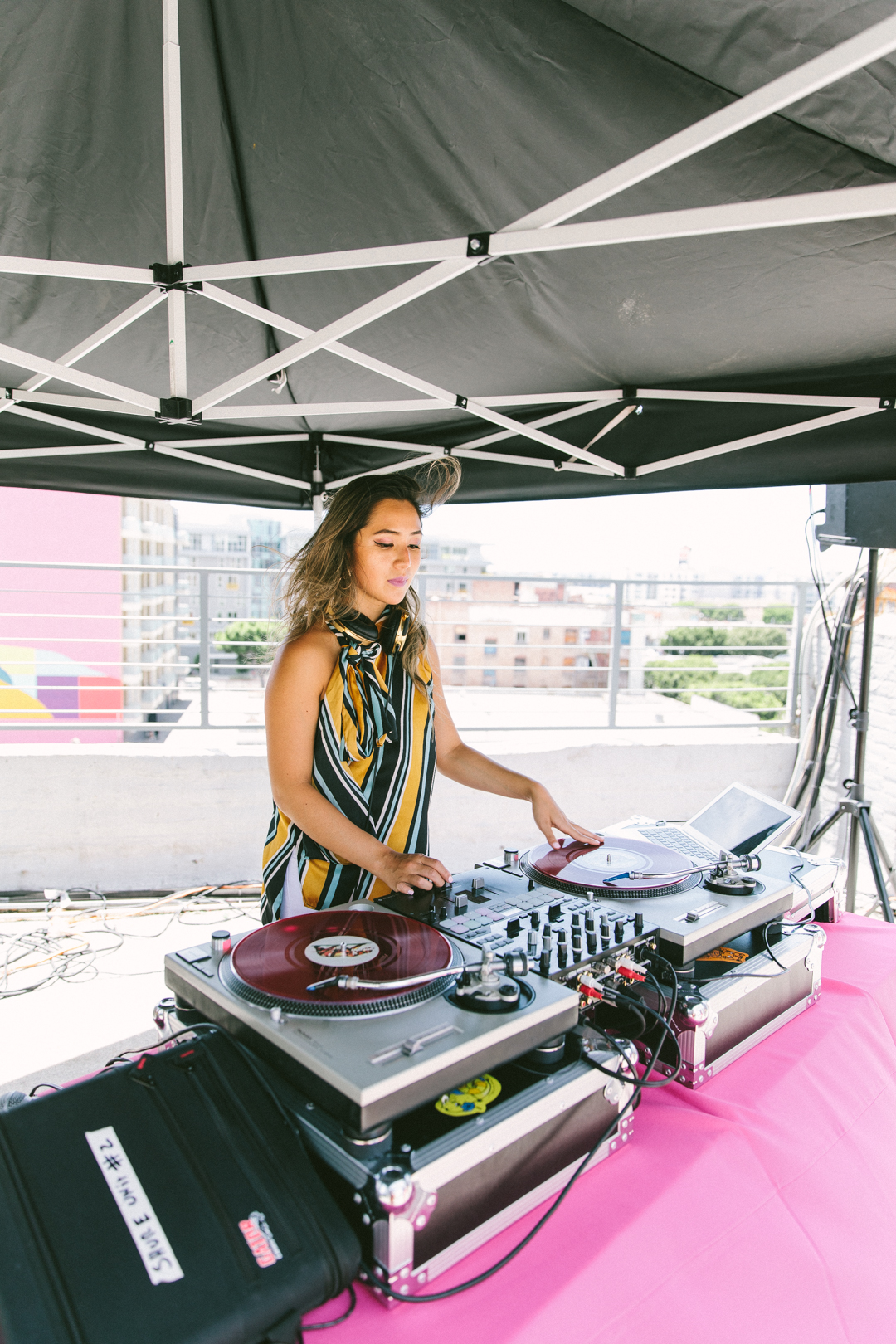 DJ spinning vinyl under the rooftop tent during the WAGcademy reception