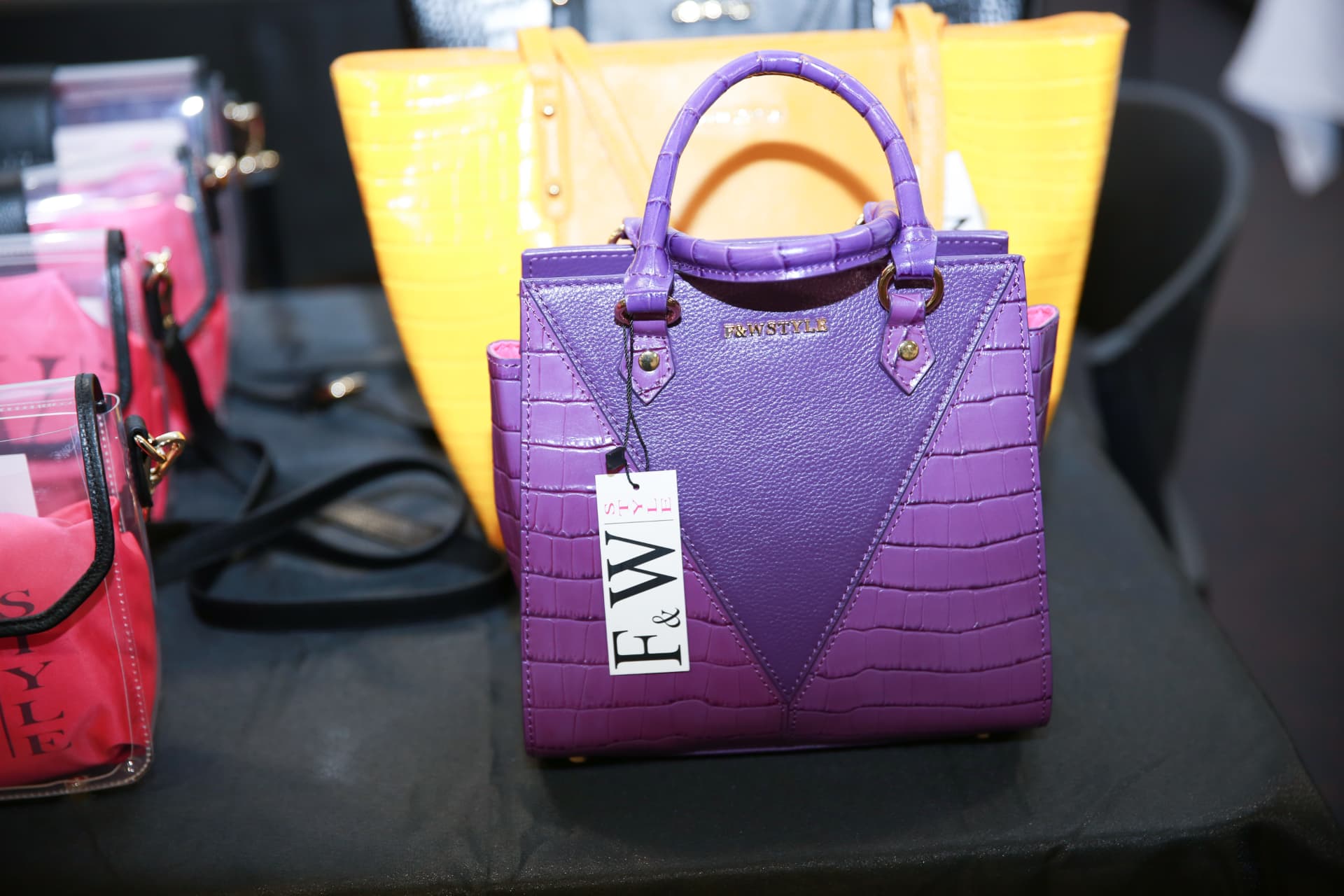 Purple F&W Style handbag on display at the Atlanta vendor table