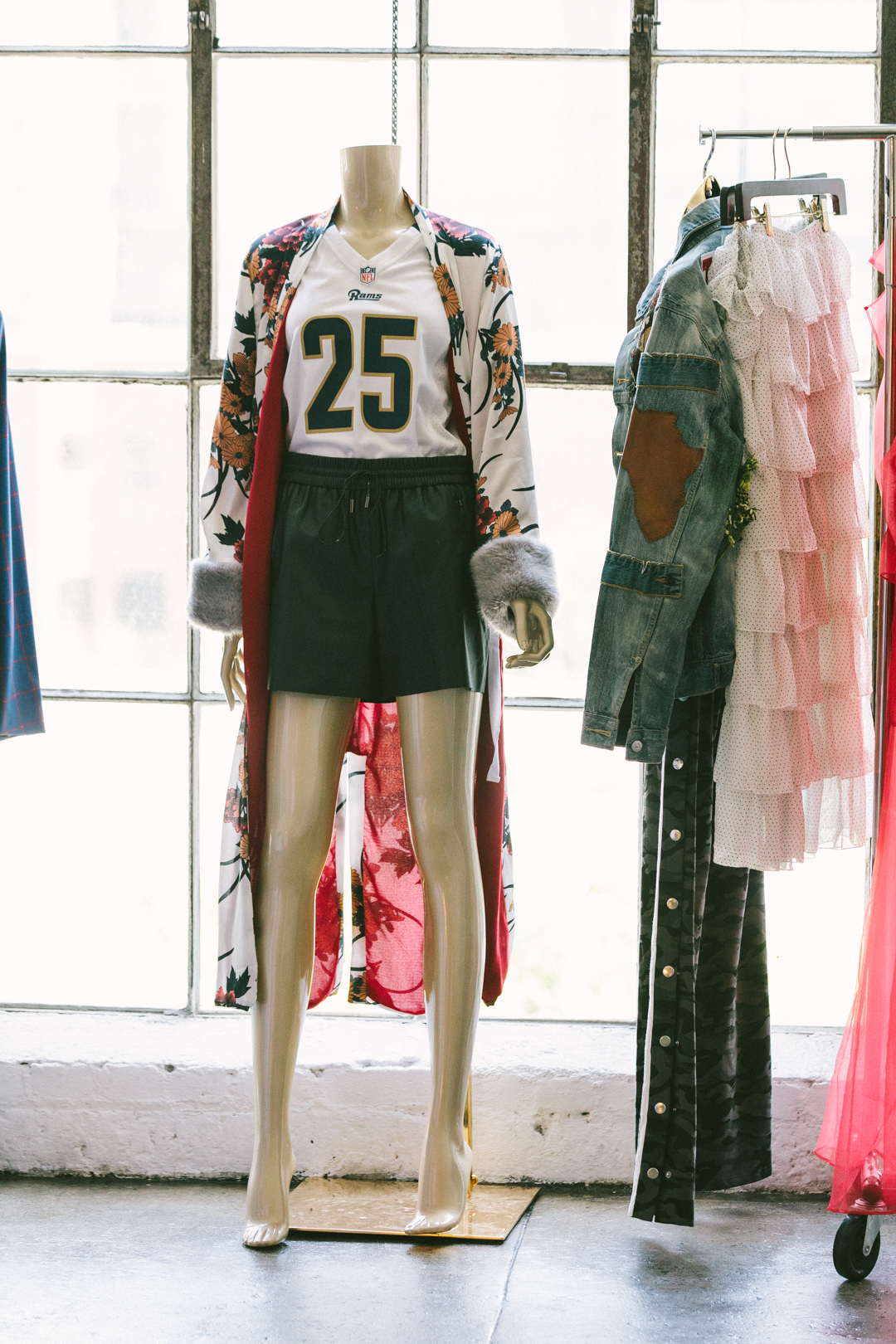 Styling activation pairing an NFL jersey with designer pieces on a rack