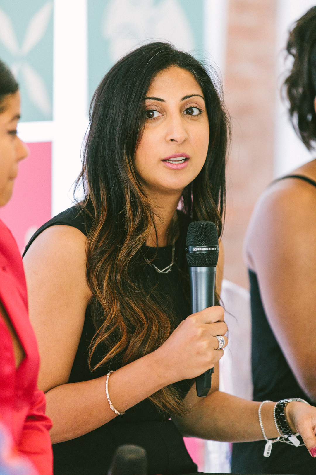 Close portrait of a WAGcademy panelist mid-answer with mic in hand