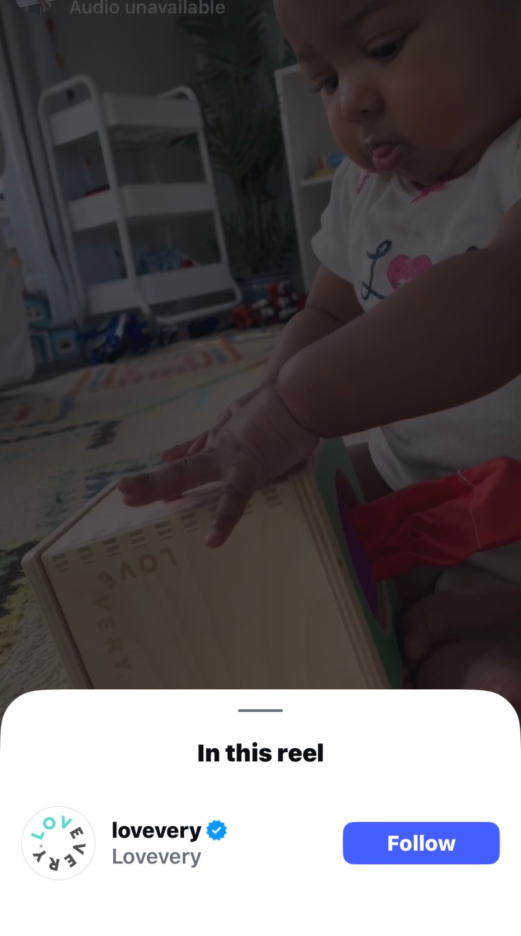 Instagram collab reel with Lovevery showing a baby reaching for a wooden Lovevery play box on a playroom rug