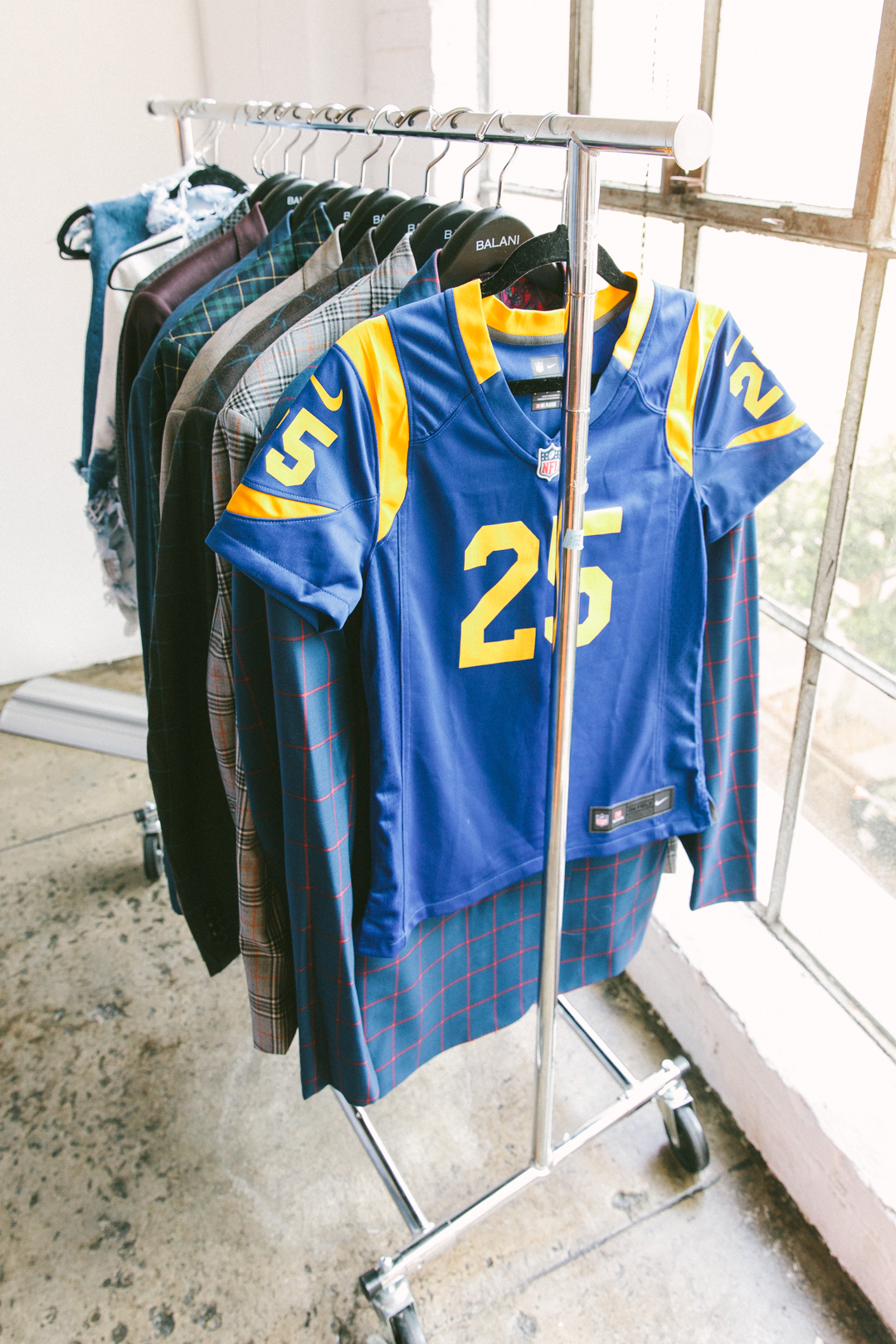 Rams jersey styled on a rack of tailored Balani suiting at the styling activation