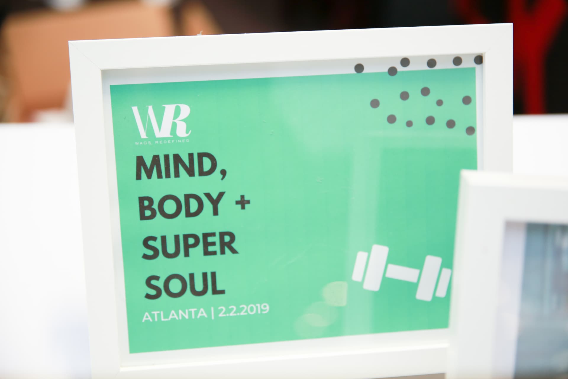 Framed Mind, Body + Super Soul Atlanta event sign in WAGS Redefined mint green