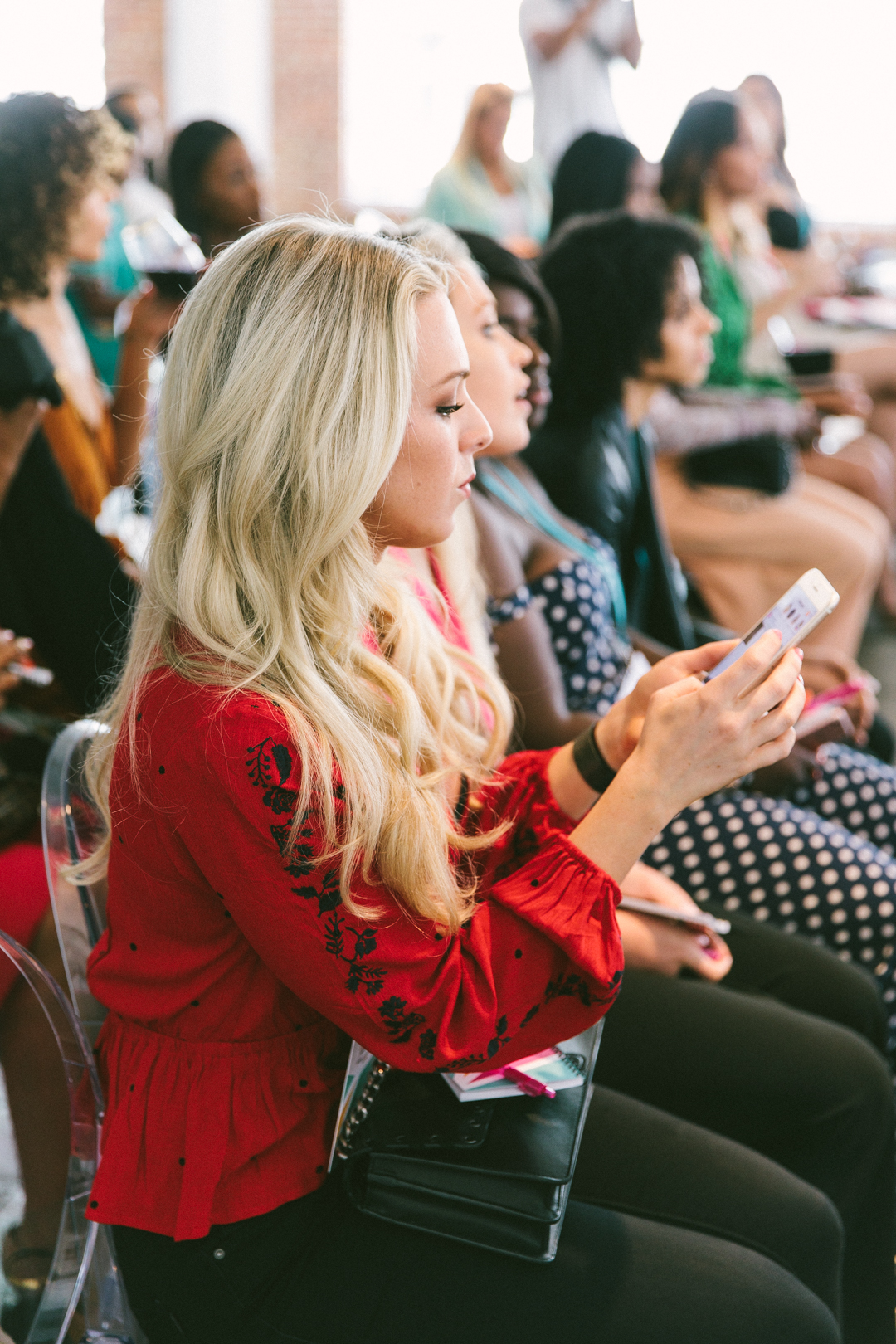 Row of attendees taking notes during a WAGcademy session