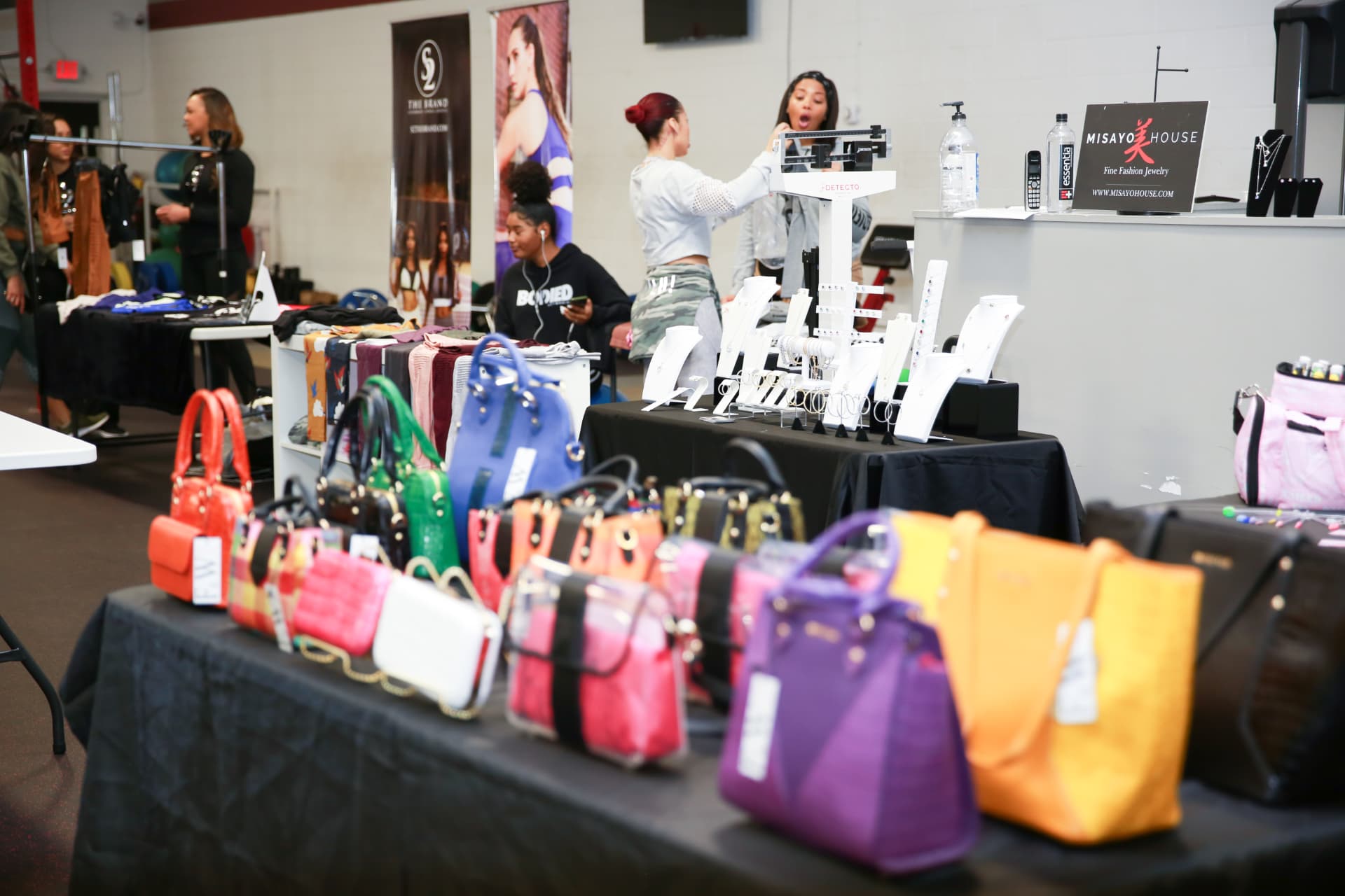 Vendor floor of handbags, apparel and jewelry set up inside the training facility