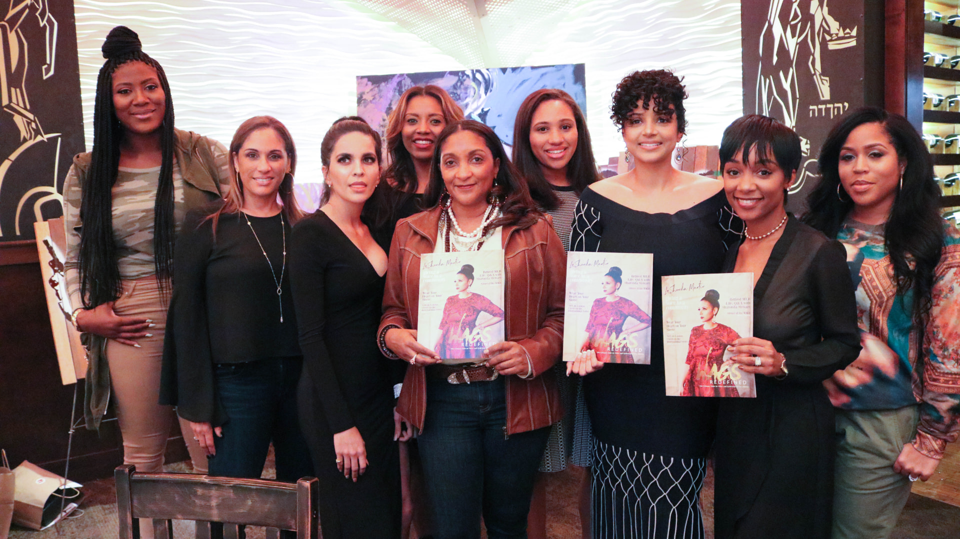 WAGS Redefined dinner guests holding the print magazine together at the Super Bowl 51 event in Houston