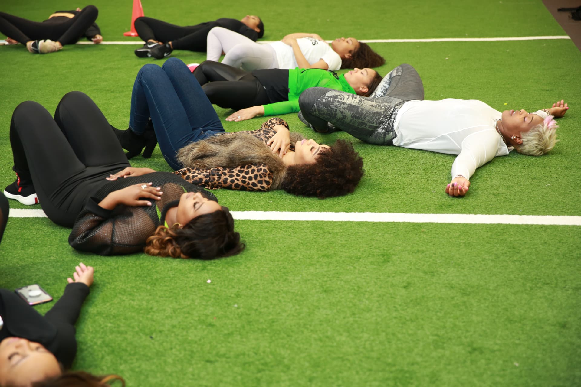 Members lying on the turf during the guided meditation
